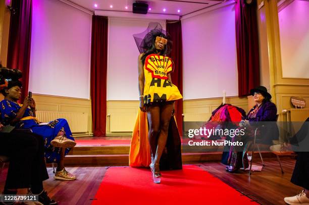 Model is wearing a dress against the oil company Shell, during the launch of 'Nopulence', the first activist clothing collection by Extinction...