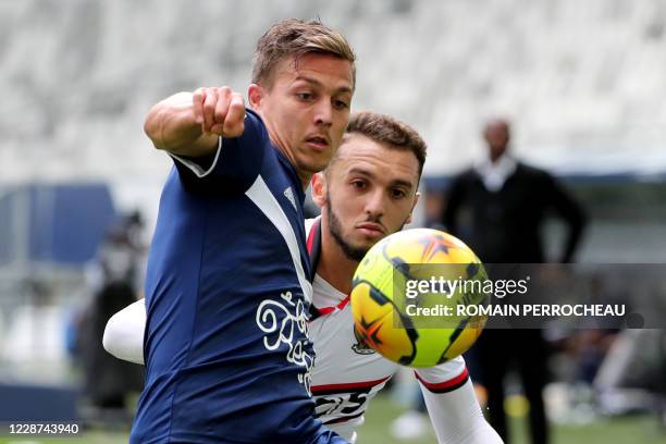 Bordeaux' French forward Nicolas De Preville and Nice's Algerian forward Amine Gouiri vie during the French L1 football match between Bordeaux and...