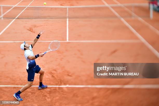 France's Elliot Benchetrit serves the ball to John Isner of the US during their men's singles first round tennis match on Day 1 of The Roland Garros...