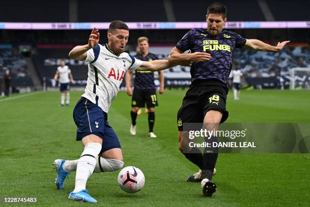Tottenham Hotspur's Irish defender Matt Doherty vies with Newcastle United's Argentinian defender Federico Fernandez during the English Premier...