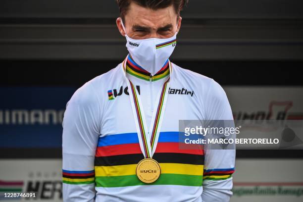 France's Julian Alaphilippe cries on the podium after winning the Men's Elite Road Race, a 258.2-kilometer route around Imola, Emilia-Romagna, Italy,...