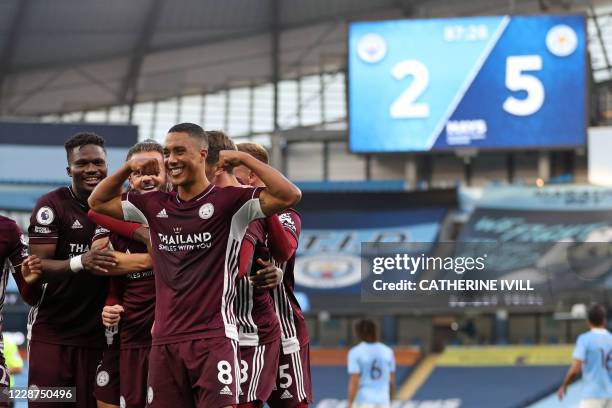 Leicester City's Belgian midfielder Youri Tielemans celebrates with teammates after scoring their fifth goal from the penalty spot during the English...