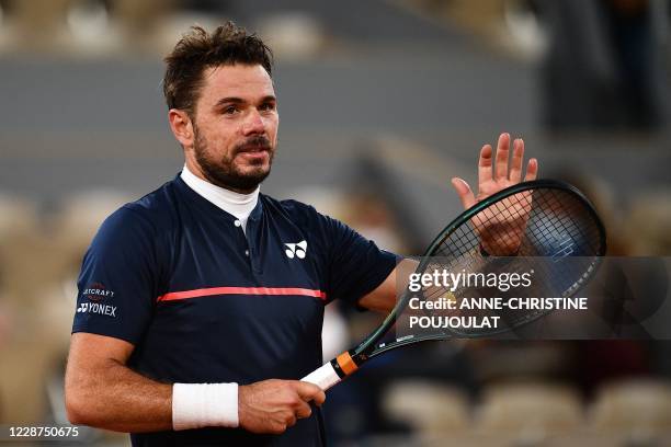 Switzerland's Stanislas Wawrinka celebrates after winning against Britain's Andy Murray during their men's singles first round tennis match on Day 1...