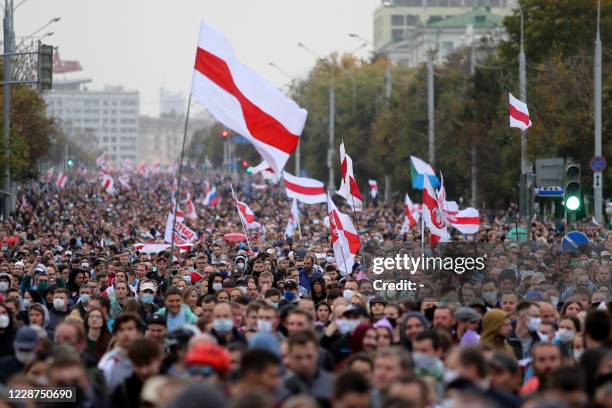 Opposition supporters parade through the streets during a rally to protest the country's presidential inauguration in Minsk on September 27, 2020....