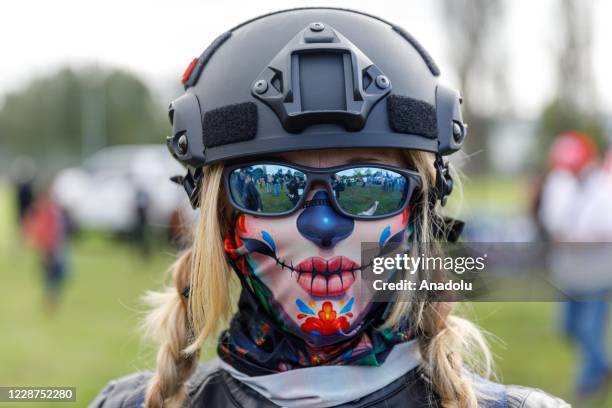 Woman wears a full face mask as the Proud Boys, a right-wing pro-Trump group, gather with their allies in a rally called âEnd Domestic Terrorismâ...