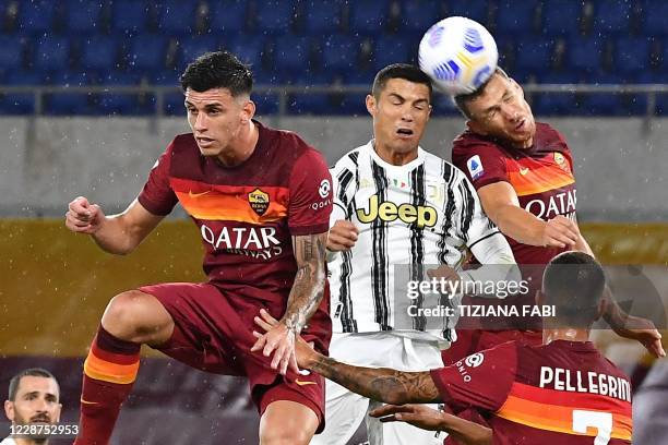 Roma's Brazilian defender Roger Ibanez, Juventus' Portuguese forward Cristiano Ronaldo and Roma's Bosnian forward Edin Dzeko go for a header during...