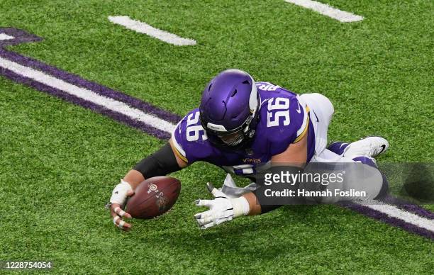 Garrett Bradbury of the Minnesota Vikings recovers a loose ball during the fourth quarter of the game against the Tennessee Titans at U.S. Bank...