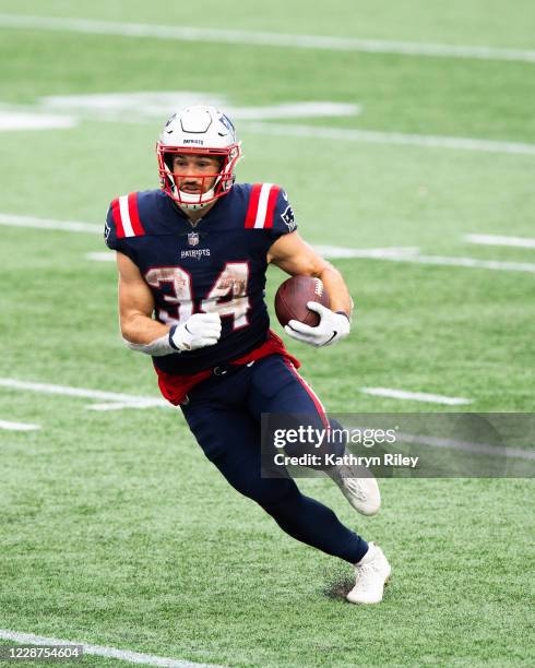 Rex Burkhead of the New England Patriots runs with the ball in the second half against the Las Vegas Raiders at Gillette Stadium on September 27,...