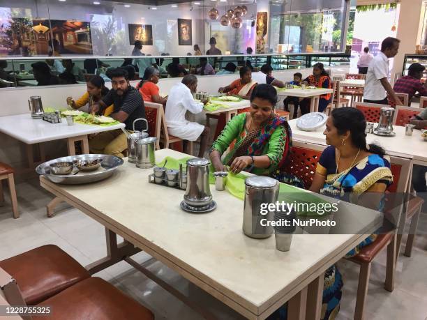 People eat a traditional vegetarian meal at an upscale South Indian restaurant in Nagercoil, Tamil Nadu, India on February 12, 2020.