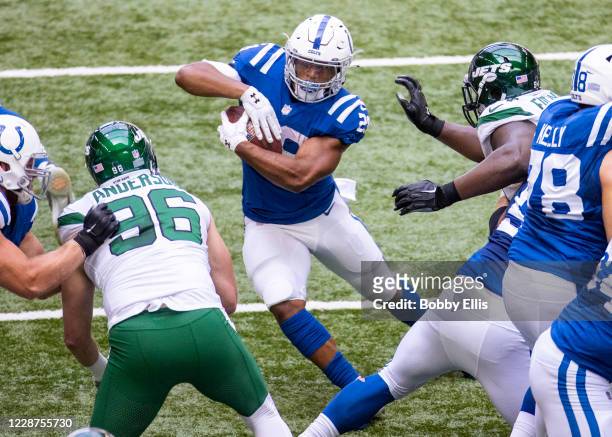 Jonathan Taylor of the Indianapolis Colts jukes past a defender as he runs downfield during the second quarter of the game against the New York Jets...