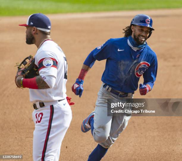 Chicago Cubs center fielder Billy Hamilton circles the bases with a home run and passes Chicago White Sox third baseman Yoan Moncada in the fourth...