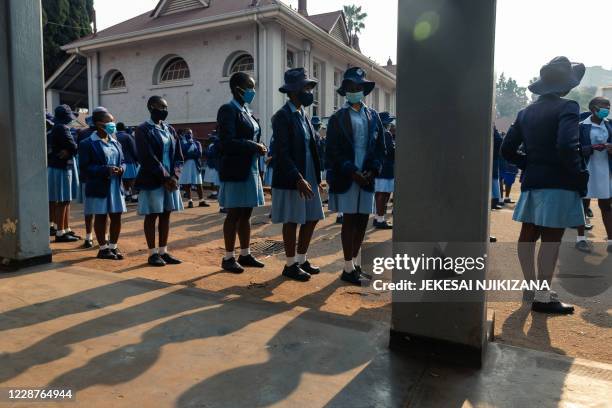 Pupils observe social distancing before school assembly at Queen Elizabeth School in Harare on September 28, 2020. Public schools in Zimbabwe have...