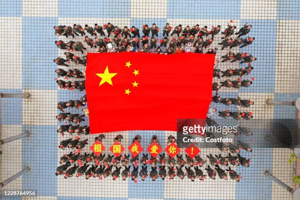 Armed police officers and soldiers hold national flags to celebrate the 71st anniversary of the founding of new China, Shenzhen, Guangdong Province,...