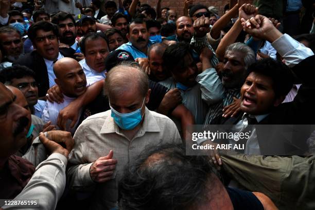 Shahbaz Sharif , Pakistani opposition leader and brother of former prime minister Nawaz Sharif, comes out from the high court surrounded by...