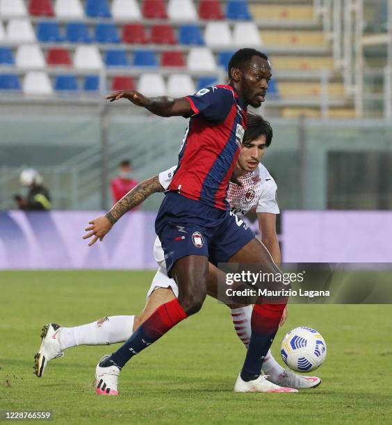 Nwankwo Simy of Crotone competes for the ball with Sandro Tonali of Milan during the Serie A match between FC Crotone and AC Milan at Stadio Comunale...