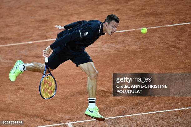 Hungary's Marton Fucsovics returns the ball to Russia's Daniil Medvedev during their men's singles first round tennis match on Day 2 of The Roland...