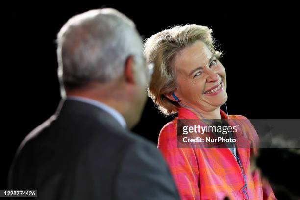 European Commission President Ursula Von Der Leyen smiles to Portuguese Prime Minister Antonio Costa as they give a press conference after their...