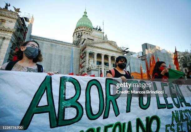 Demonstrators hold a banner outside the Congress during a demonstration in favor of decriminalization of abortion on the International Safe Abortion...