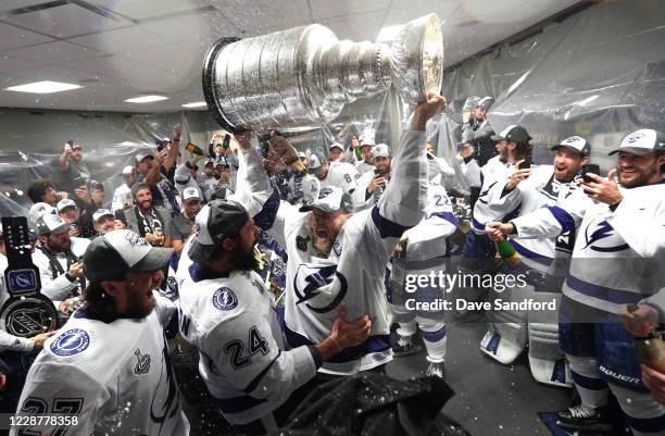Captain Steven Stamkos and his Tampa Bay Lightning teammates celebrate with the Stanley Cup in the locker room after the Tampa Bay Lightning defeated...