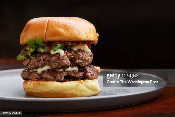 La Hamburguesa - Queso Oaxaca, Salsa Macha, Smoked Tomatillo Relish, Cilantro and Double Patty at the Ghostburger pop up at Espita photographed in...