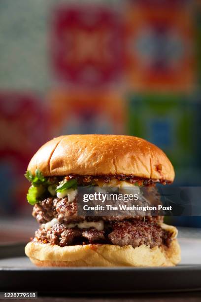 La Hamburguesa - Queso Oaxaca, Salsa Macha, Smoked Tomatillo Relish, Cilantro and Double Patty at the Ghostburger pop up at Espita photographed in...