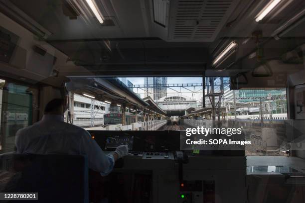 Yamanote Line train conductor steers a train bound for Ikebukuro in Tokyo .