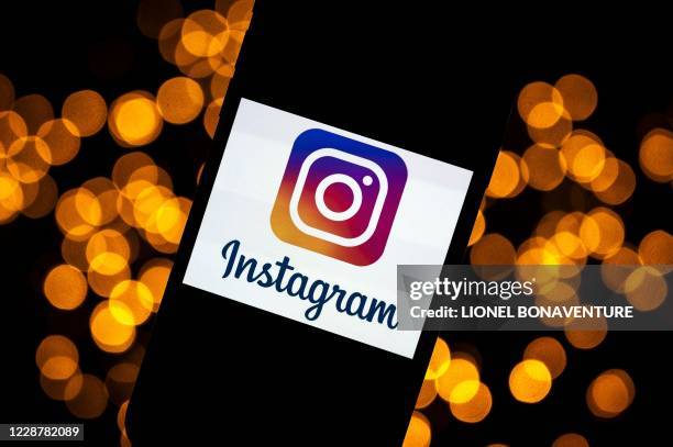 This picture taken on September 28, 2020 shows the logo of the social network Instagram on a smartphone, in Toulouse, southwestern France. - The...