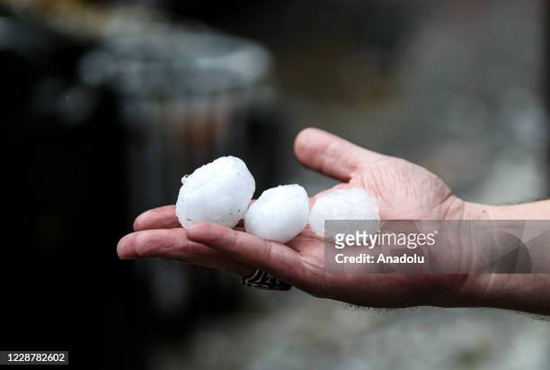 Man holds hailstones after heavy rain and hail fall hit Uskudar district in Istanbul, Turkey on September 29, 2020.