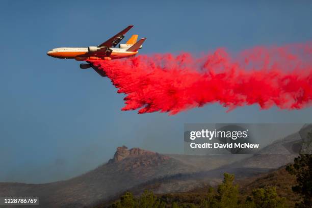 Air Tanker 914 DC-10 jet drops fire retardant over the Martindale Fire on September 28, 2020 near Santa Clarita, California. The fire threatened...