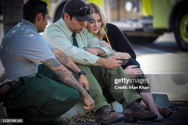 Mojave hand crew Brandon Urquizu, Anthony Avalos from San Bernardino National Forest, and his girlfriend Samantha Wells watch the memorial service...