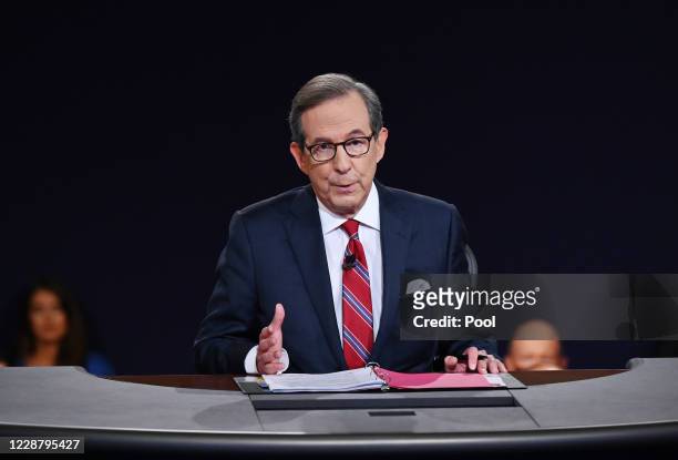 Debate moderator and Fox News anchor Chris Wallace directs the first presidential debate between U.S. President Donald Trump and Democratic...
