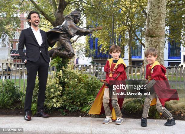 Alex Zane and 2 Harry Potter fans by the statue of Harry Potter which was unveiled in Leicester Square as part of the 'Scenes in the Square' film...
