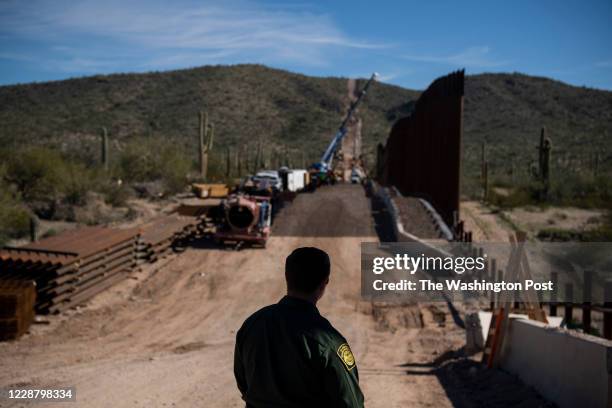 Border Patrol Agent Joe Curran looks at the border fence construction in the Organ Pipe Cactus National Monument in Lukeville, AZ on January 7, 2020.