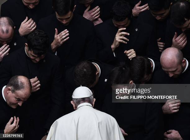 Pope Francis prays with priests at the end of a limited public audience at the San Damaso courtyard in The Vatican on September 30, 2020 during the...