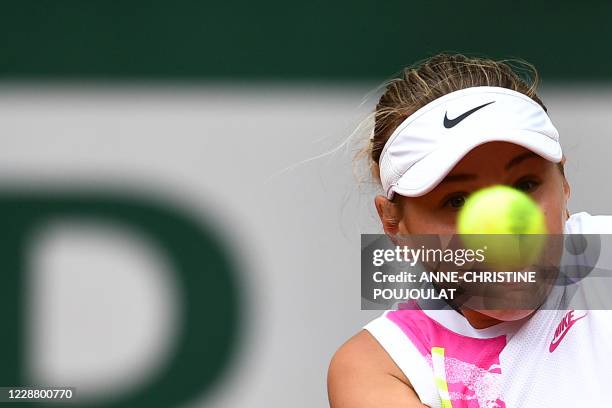 Amanda Anisimova of the US eyes the ball as she returns it to Bernarda Pera of the US during their women's singles second round tennis match at the...