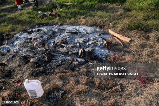 View of the funeral pyre remains of the 19-year-old woman, who was allegedly gang-raped by four men, on the outskirts of Bool Garhi village in...
