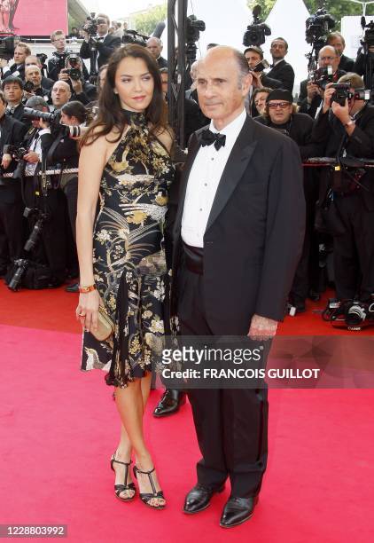 French actor and singer Guy Marchand and his wife Adelina pose as they arrive to attend the opening ceremony and the screening of Brazilian director...