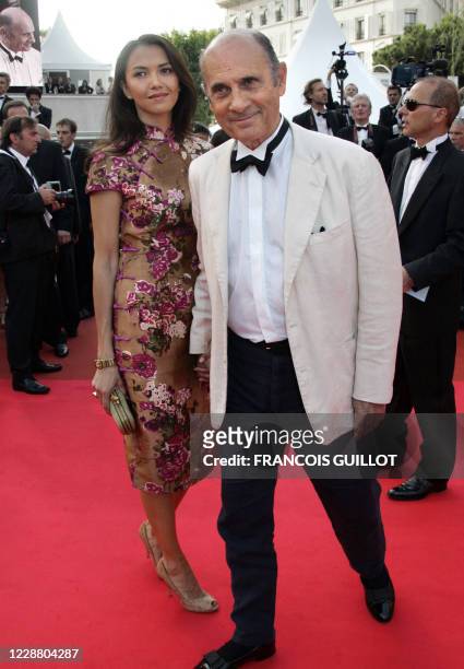 French actor and singer Guy Marchand arrives 22 May 2007 with his wife Adelina at the Festival Palace in Cannes, southern France, for the screening...