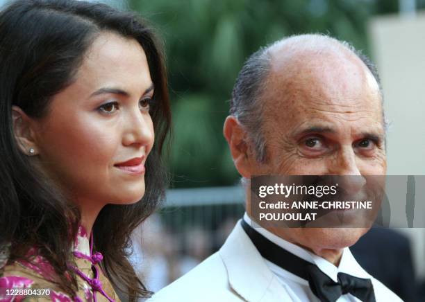 French actor and singer Guy Marchand poses 22 May 2007 as he arrives with his wife Adelina at the Festival Palace in Cannes, southern France, for the...