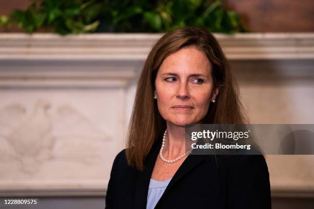 Amy Coney Barrett, U.S. President Donald Trump's nominee for associate justice of the U.S. Supreme Court, listens while meeting with Senator Shelley...