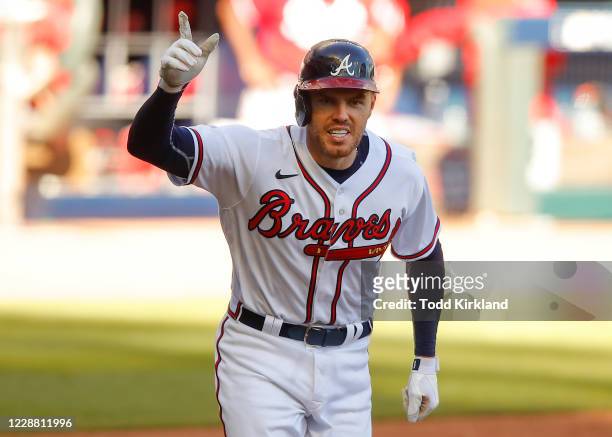 Freddie Freeman of the Atlanta Braves reacts after hitting a single to score a run and win the game in the thirteenth inning of Game One of the...