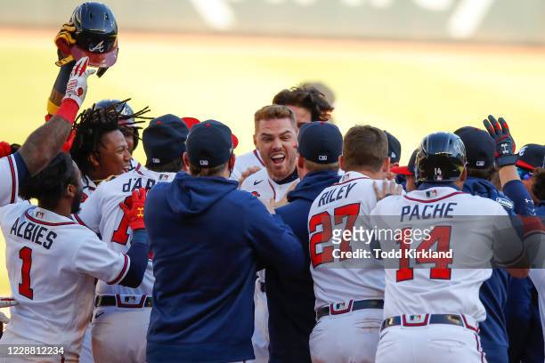 Freddie Freeman of the Atlanta Braves reacts after hitting a single to bring in the winning run in the thirteenth inning of Game One of the National...