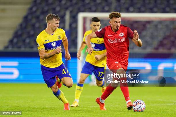 Mergim Berisha of Salzburg takes the ball into the attacking zone followed by Eden Karzev of Tel Aviv during the UEFA Champions League Play-Off...