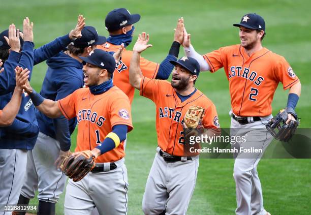 Carlos Correa, Jose Altuve and Alex Bregman of the Houston Astros celebrate defeating the Minnesota Twins in Game Two in the American League Wild...