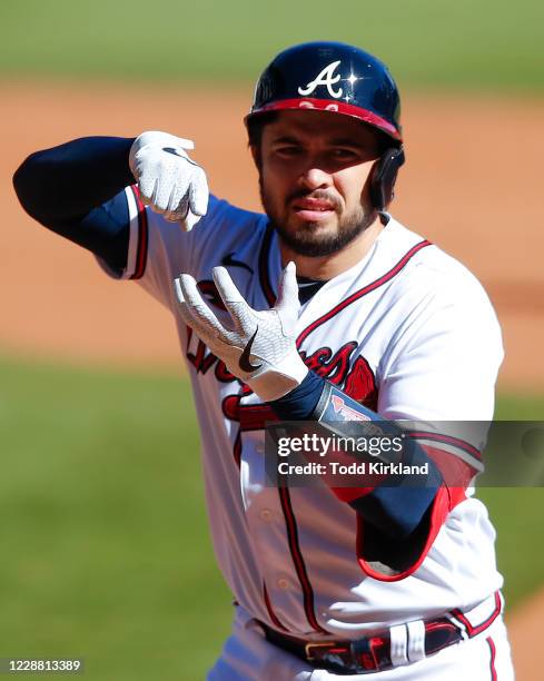 Travis d'Arnaud of the Atlanta Braves reacts after he singles in inning twelve of Game One of the National League Wild Card Series against the...