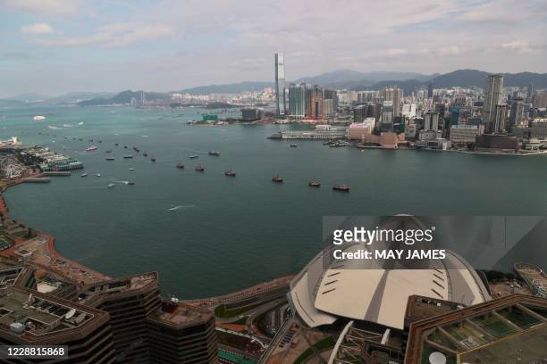 Fishing vessels carrying slogans and Chinese national flags sail in formation through Victoria Harbour during China's National Day in Hong Kong on...