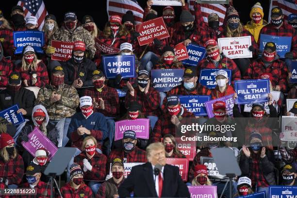 Attendees clap as U.S. President Donald Trump, front, speaks during a 'Make America Great Again' rally in Duluth, Minnesota, U.S., on Wednesday,...