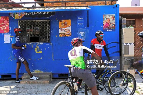 Riders buy goods from a streetside shop during a Heritage ride from Vilakazi Street on September 26, 2020 in Soweto South Africa. Celebrating...