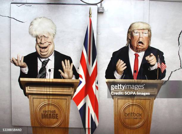 Prime Minister Boris Johnson and US President Donald Trump are pictured in this panel. Caricatures of politicians on large advertisement board for...