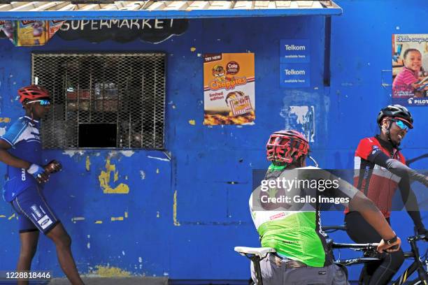 Riders buy goods from a streetside shop during a Heritage ride from Vilakazi Street on September 26, 2020 in Soweto South Africa. Celebrating...